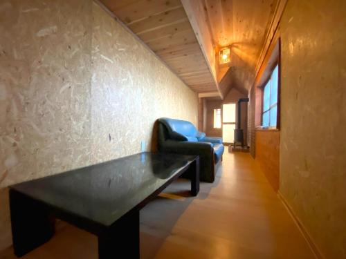 a living room with a bench and a chair at Fukouji - Vacation STAY 07341v in Numata
