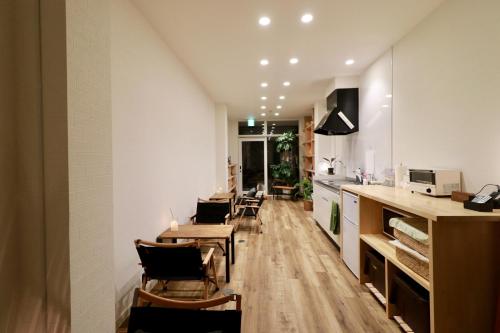 a kitchen and dining room with tables and chairs at WAKURIAN,iwatacho - Vacation STAY 98982v in Okayama