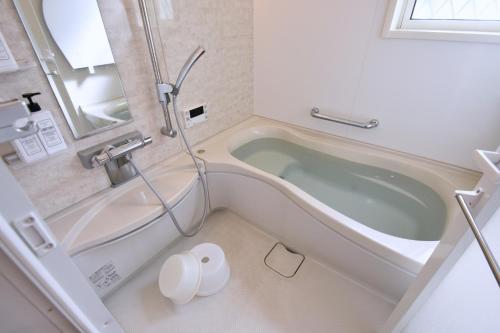 a bathroom with a tub and a sink at Magical Dream House ★ Maihama - Vacation STAY 12402 in Tokyo