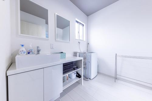 a white bathroom with a sink and a refrigerator at IDSTAY Lake Kawaguchi-Urushi- - Vacation STAY 02427v in Azagawa