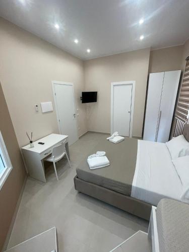 a bedroom with a bed and a desk and a sink at Catapano's House in Pompei