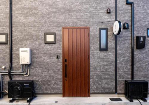 a wooden door on the side of a building at HAKATA TERRACE -akari- - Vacation STAY 12420 in Fukuoka