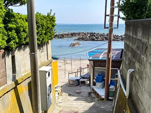 a view of a beach with the ocean and a building at Trawl - Vacation STAY 55770v in Kamakura