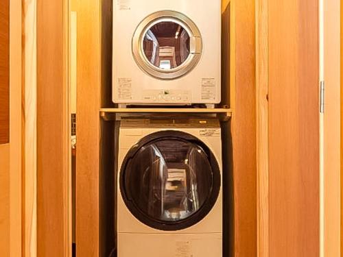 a washing machine with a microwave on top of it at Trawl - Vacation STAY 55770v in Kamakura