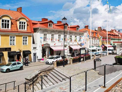a city street with cars parked in front of buildings at 6 person holiday home in GRÄNNA in Gränna