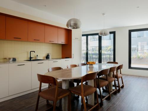 a kitchen and dining room with a table and chairs at Edgar Suites Levallois - Anatole France in Levallois-Perret