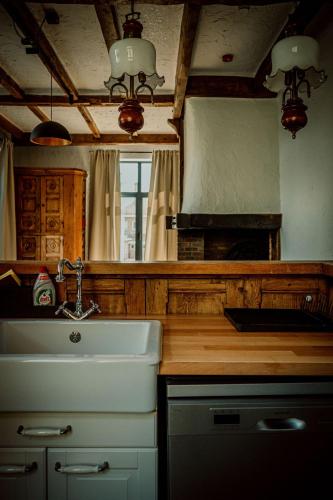 a kitchen with a sink and a counter top at Relais M in Frasnes-lez-Anvaing