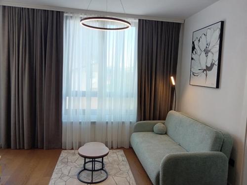 a living room with a couch and a table at Apartman Tri vrha Spa & Wellness Zlatibor in Zlatibor