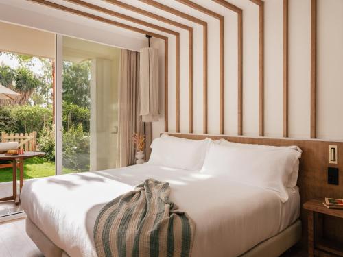 a bedroom with a large bed and a large window at ME Marbella by Meliá in Marbella