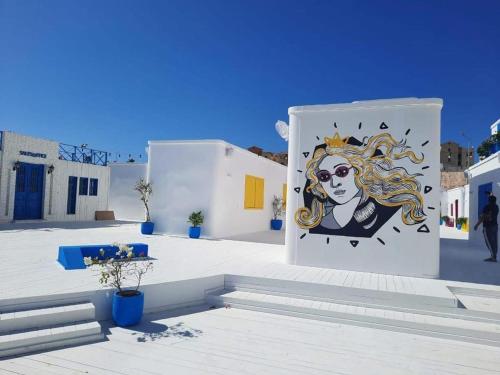 a wall with a painting of a woman on it at Mountain View Resort Chalet in Ras El Hekma in Ras Elhekma