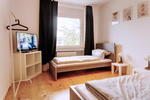 Postel nebo postele na pokoji v ubytování Workerslodge - Wohnung für 6 P in Krefeld