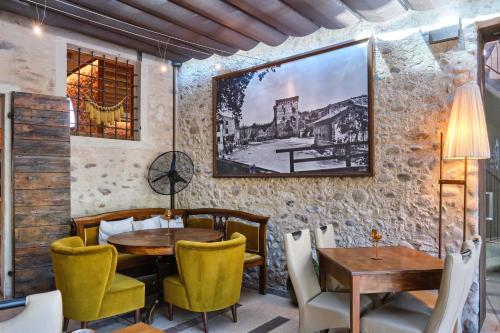 a restaurant with a table and chairs and a picture on the wall at Corte Regia Relais & Spa in Valeggio sul Mincio