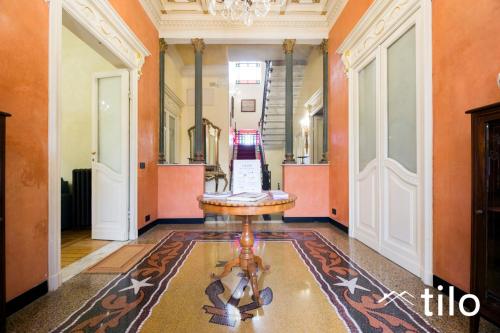 a hallway with a table in the middle of a room at Villa Aranci | Historical Residence | By Tilo Lux in Genova