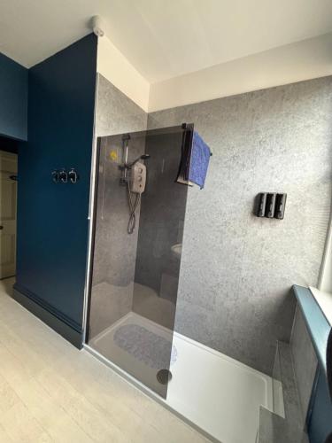 a shower with a glass door in a bathroom at Church Stretton Shropshire Hills in Church Stretton