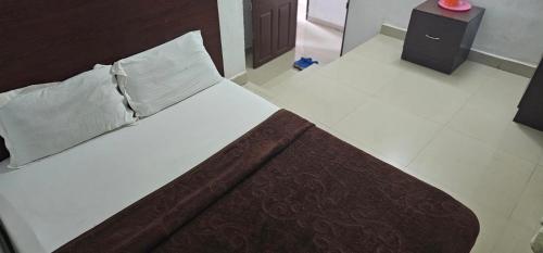 a large bed in a room with at The Green Regency Annexe in Munnar