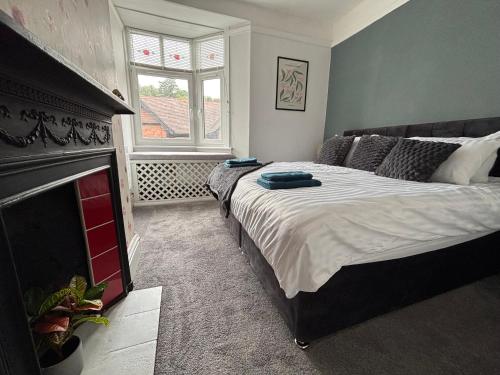 a bedroom with a large bed and a fireplace at Church Stretton Shropshire Hills in Church Stretton