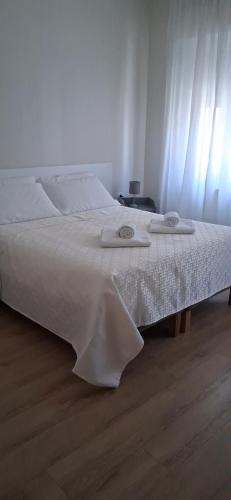 a bedroom with a bed with two towels on it at Affittacamere Risorgimento in Lecco