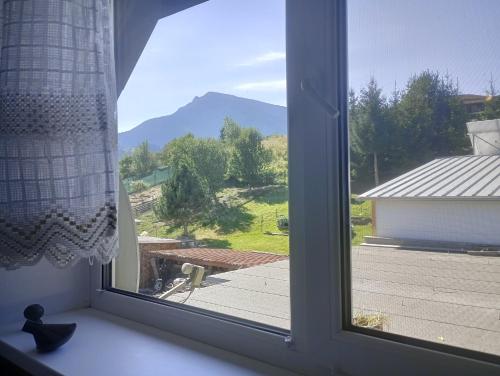 a window with a view of a mountain view at Ubytovanie FIORA in Vyšný Kubín