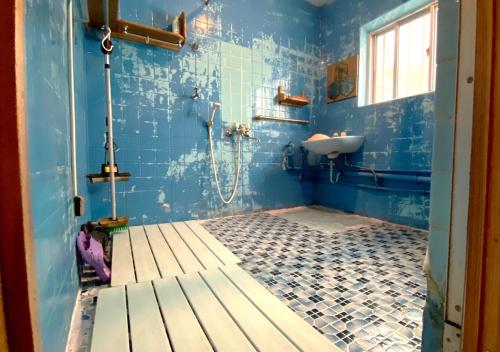 a blue bathroom with a sink and a shower at Guest house Icyaribacyoude - Vacation STAY 09894v in Naha