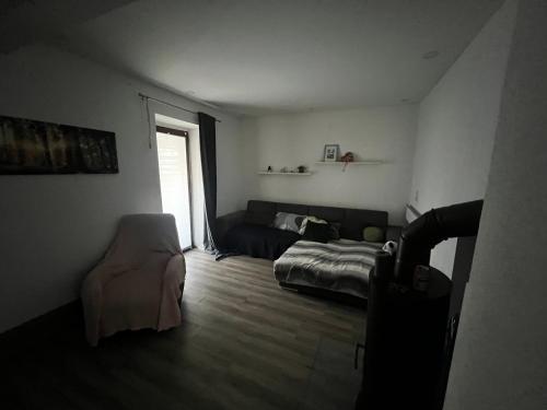 a living room with a bed and a couch at Casa Relax in Höhr-Grenzhausen