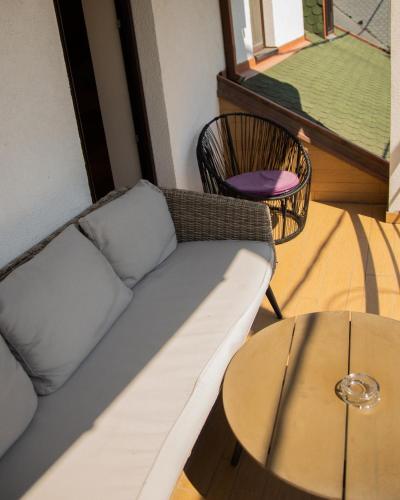 a living room with a couch and a table at Guest House Panorama Aqualux with Free Parking in Novi Sad