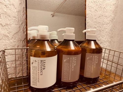a group of four bottles of wine in a rack at uminca - Vacation STAY 09850v in Numazu