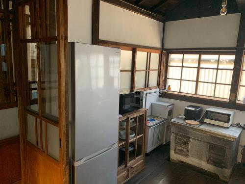a small kitchen with a refrigerator and a stove at uminca - Vacation STAY 09850v in Numazu