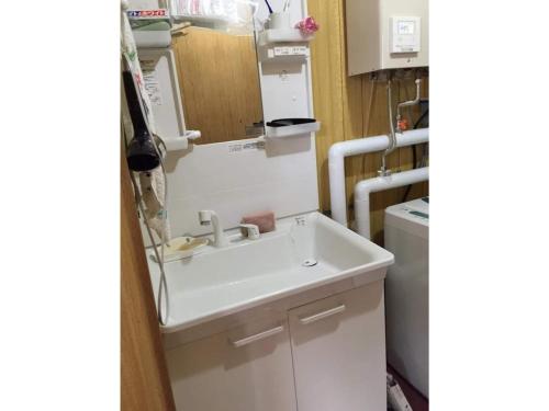 a kitchen with a sink and a refrigerator at Guest House Hagoromo 39 - Vacation STAY 12003v in Kiyosato