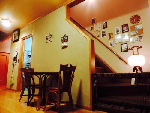 a dining room with a table and chairs and a staircase at Kumamoto Farm Stay 2F - Vacation STAY 12481 in Takemiya