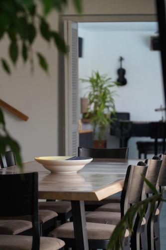 a wooden table with chairs and a bowl on it at Maison Toulouse in Affligem