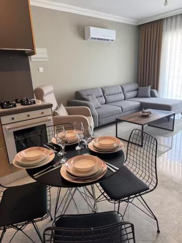 a living room with a table and chairs and a couch at Royal Sun Elite Daire in Aglantzia