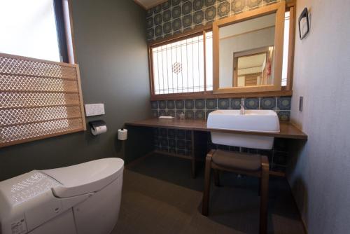 a bathroom with a toilet and a sink and a mirror at Izumo - House - Vacation STAY 13870v in Izumo