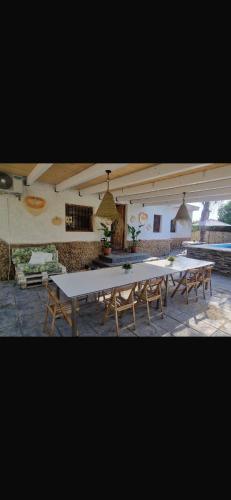 a large white table and benches in a room at Villas de encanto in Vilamarxant
