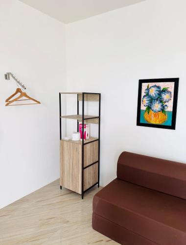 a living room with a book shelf and a couch at A & L Resort - Sea & Mountain View in Looc
