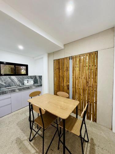 a dining room with a wooden table and chairs at A & L Resort - Sea & Mountain View in Looc