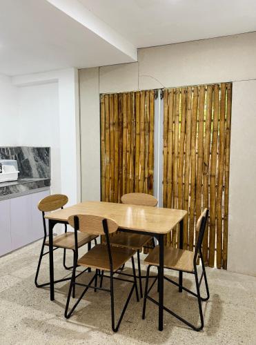 a dining room with a wooden table and chairs at A & L Resort - Sea & Mountain View in Looc