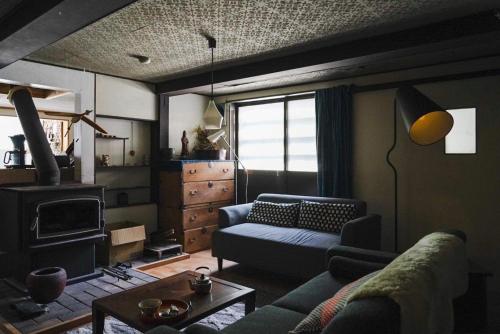 a living room with a couch and a fireplace at Arimaya - Vacation STAY 14255v in Mitsumata