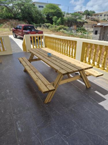a wooden bench sitting on top of a patio at Casa Andries Montanja Rey in Willemstad
