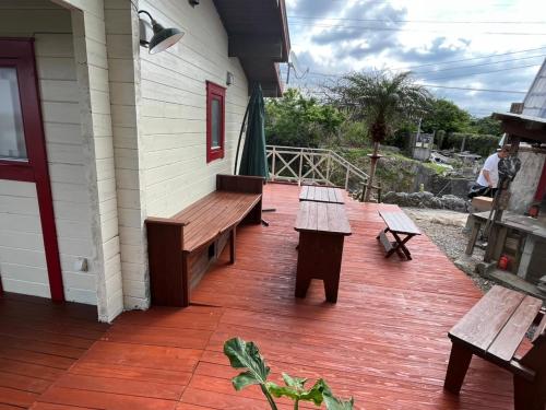 a porch with wooden benches on a house at Sesoko Log Cabin [Chimu lani] - Vacation STAY 26745v in Sesoko