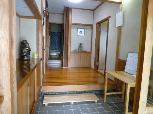 an empty room with a wooden table and a hallway at GuestHouse AZMO - Vacation STAY 48007v in Matsue