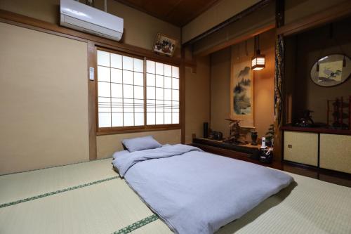 a bedroom with a bed and a large window at Hotaru no Yado - Vacation STAY 24964v in Sumoto
