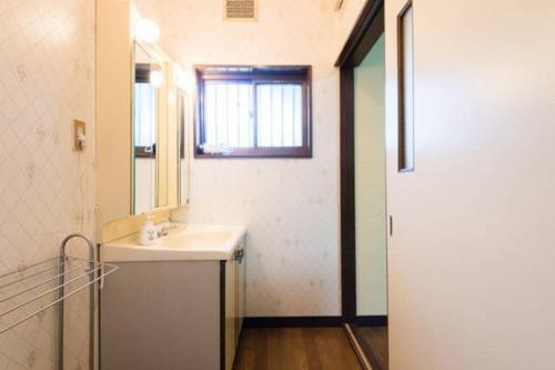 a bathroom with a sink and a mirror and a window at someya - Vacation STAY 33875v in Kyoto