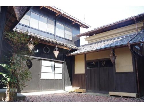 a house with a garage with two baskets on it at base sanablend - Vacation STAY 04857v in Kyotango
