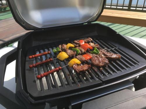 a grill with some meat and vegetables on it at HARBOR TERRACE RYUGATAKE - Vacation STAY 28730v in Takakushi