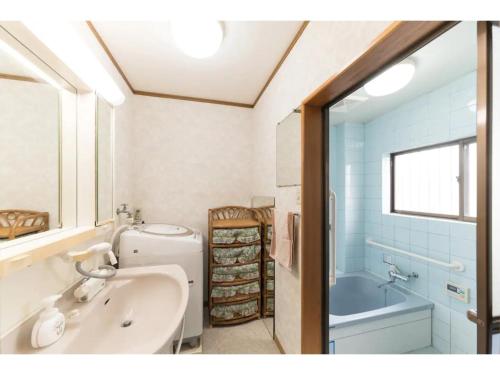 a bathroom with a sink and a tub and a toilet at Yado wa Good Rich - Vacation STAY 30399v in Tokushima