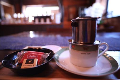 a cup of coffee sitting on a plate next to a container at Cominka - Vacation STAY 30137v in Chino