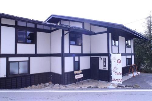 a black and white building with a sign in front of it at Cominka - Vacation STAY 30137v in Chino