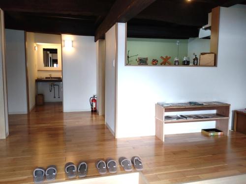 a room with a wooden floor and a table with shoes at Yubitoya - Vacation STAY 44210v in Kawaba