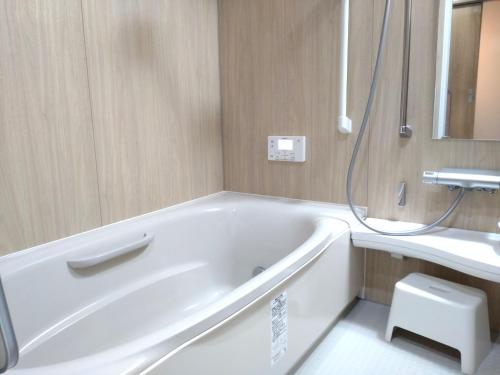 a white bath tub in a bathroom with a sink at Yubitoya - Vacation STAY 44210v in Kawaba