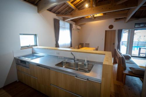 a kitchen with a sink and a counter top at Villa Muse Okinawa- Vacation STAY 43827v in Nago